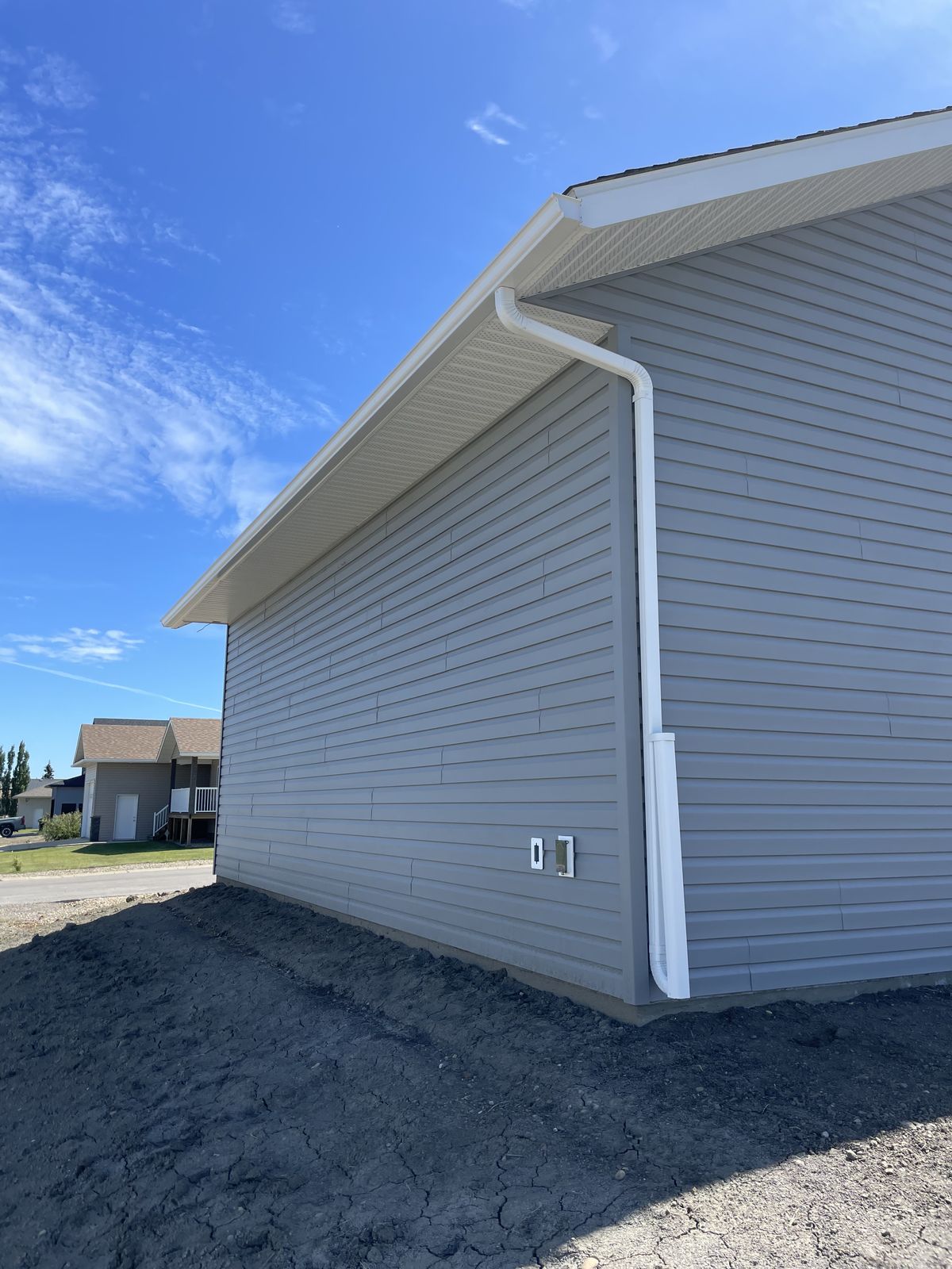 Completed gutter installation project on a Dawson Creek property