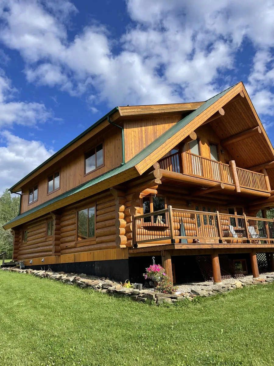 Log home with completed gutter installation