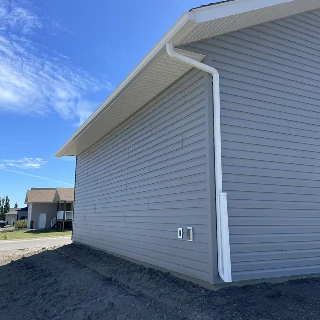 Completed gutter installation project on a Dawson Creek property